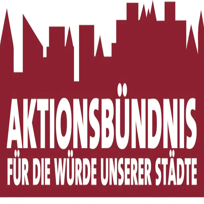 Foto: In wei&szlig;er Schrift steht geschrieben: "Aktionsb&uuml;ndnis - F&uuml;r die W&uuml;rde unserer St&auml;dte". Im Hintergund ist in roter Farbe die Skyline einer Stadt zu sehen.