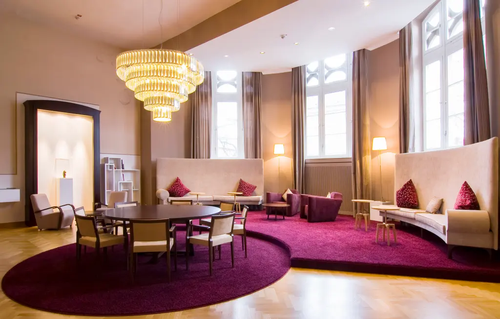 Foto: Das Trauzimmer in der Lounge des Osthaus Museum mit einem großen Kronenleuchter und einem luxuriösen Teppich.